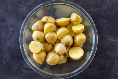 Seasoned sliced potatoes on a bowl.