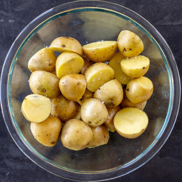 Seasoned sliced potatoes on a bowl.