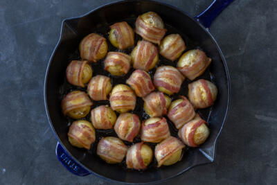 Bacon Wrapped Potatoes on a baking dish.