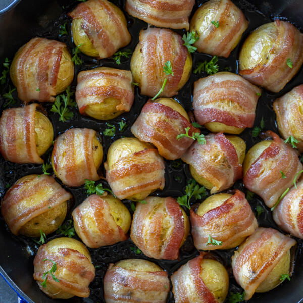 Baked Bacon Wrapped Potatoes on a pan.