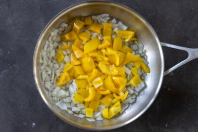 Onions and bell pepper in a pan.