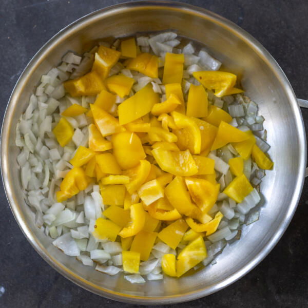 Onions and bell pepper in a pan.