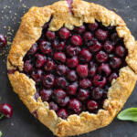 Baked Cherry Galette with basil and cherries next to it.