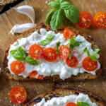 Cottage Cheese Toast with tomatoes on a side.