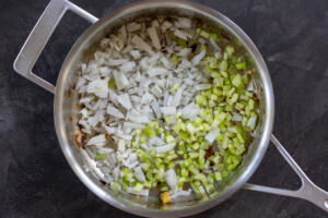 Onion and celery in a pan.