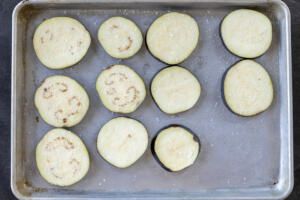 Seasoned eggplant on a baking sheet.