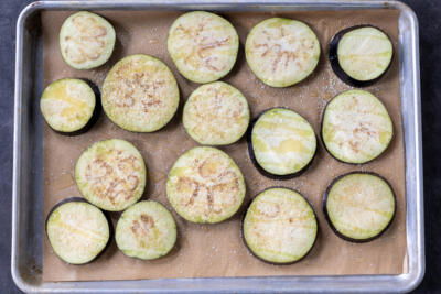 Seasoned eggplant on a baking sheet.