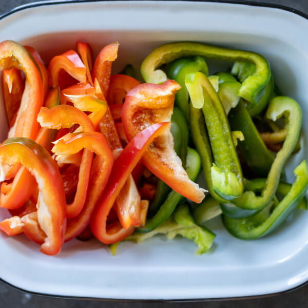Sliced up bell pepper in a pan.