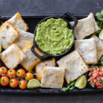 Sheet Pan Quesadilla with guac and other tomatoes.