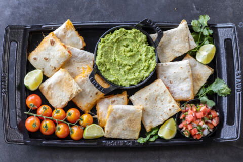 Sheet Pan Quesadilla with guac and other tomatoes.