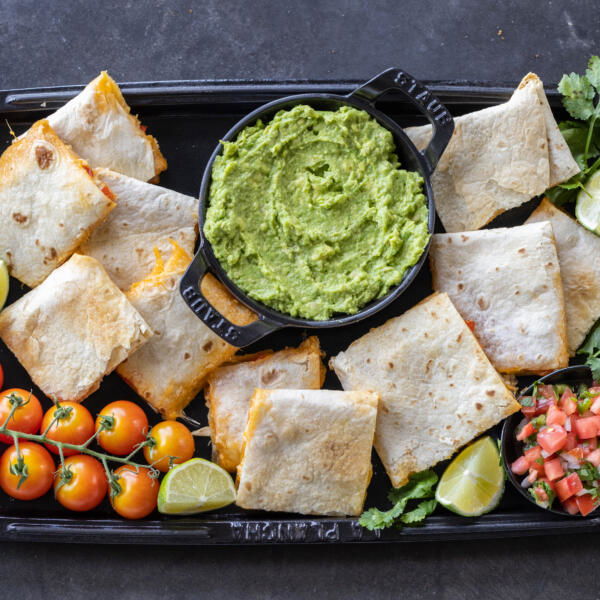 Sheet Pan Quesadilla with guac and other tomatoes.