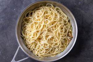 Pasta added to zucchini with sauce.