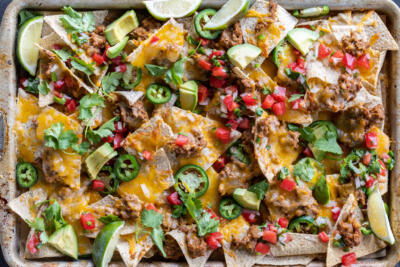 Sheet Pan Nachos with different toppings.
