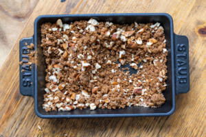 Brown sugar, nuts and cinnamon in a plate.