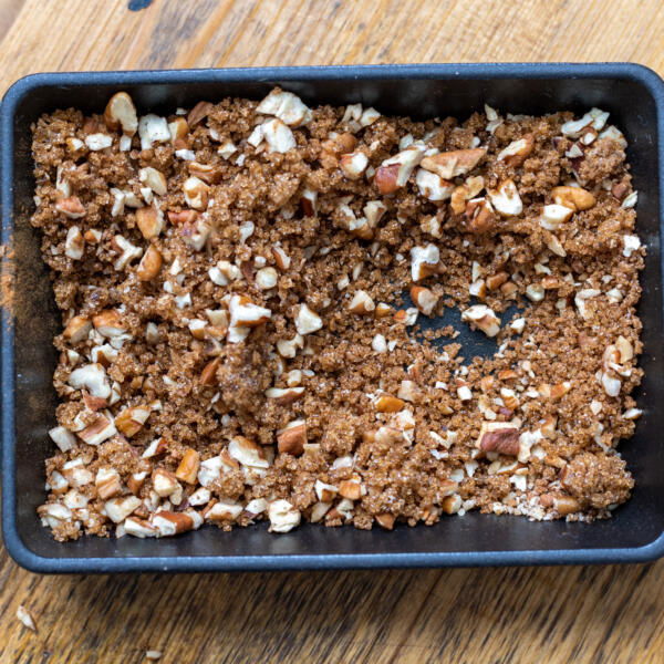 Brown sugar, nuts and cinnamon in a plate.