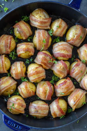 Baked Bacon Wrapped Potatoes on a pan.