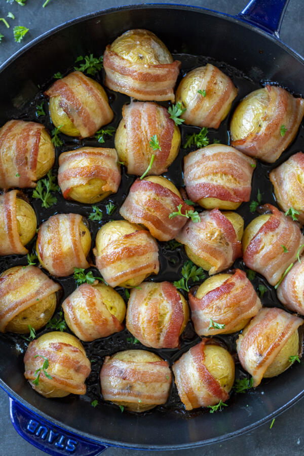 Baked Bacon Wrapped Potatoes on a pan.