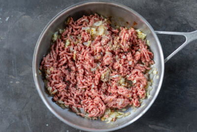 Onion and ground beef in a pan.