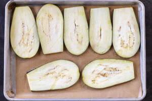 Slices of eggplant on a baking sheet.