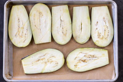 Slices of eggplant on a baking sheet.
