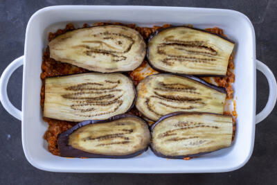 Slices of eggplant in a pan.