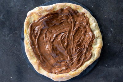 Pizza crust with nutella on top.