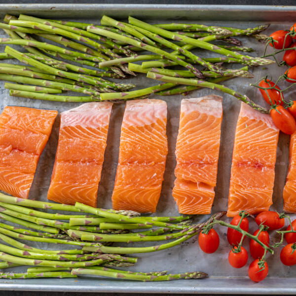 Salmon with veggies on a baking sheet.