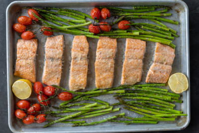 Baked salmon and veggies on a tray.