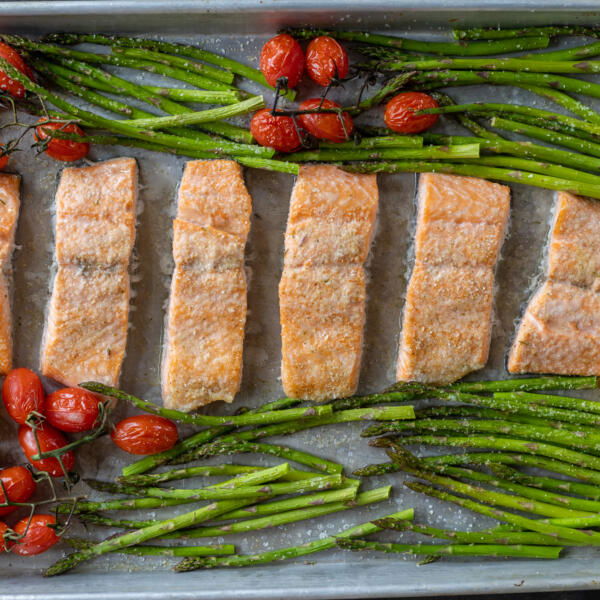 Baked salmon and veggies on a tray.