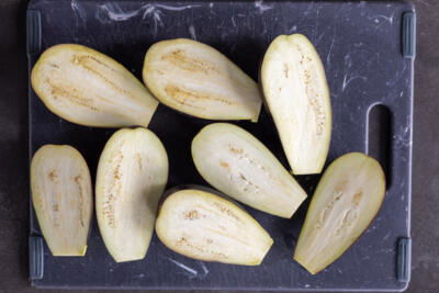 Sliced eggplant on a cutting board.