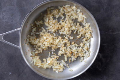 Onions cooking in a pan.