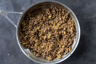 Meat and onions in a pan.