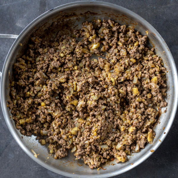Meat and onions in a pan.