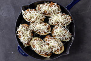 Stuffed Eggplant with cheese on top before baking.