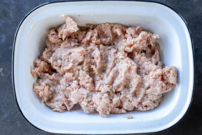 Pork with seasoning in a bowl.