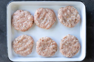 Shaped Homemade Sausage Patties on a tray.