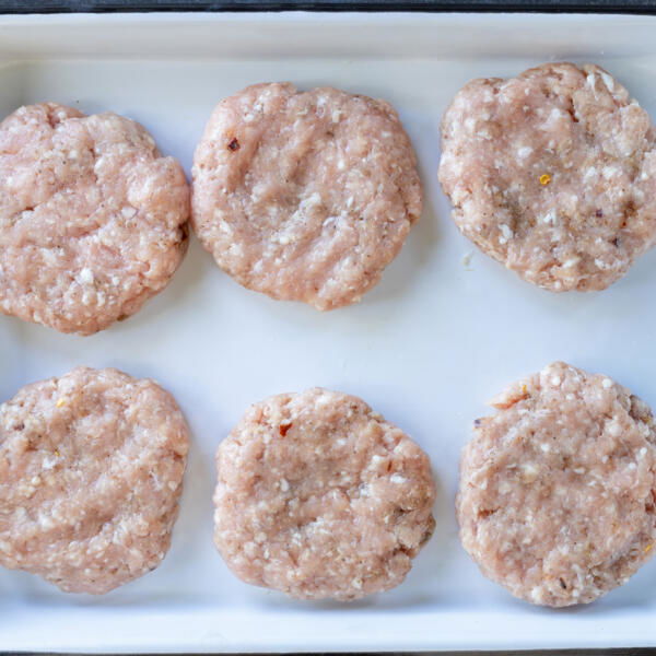 Shaped Homemade Sausage Patties on a tray.