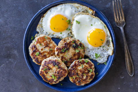 Plated Homemade Sausage Patties with eggs.