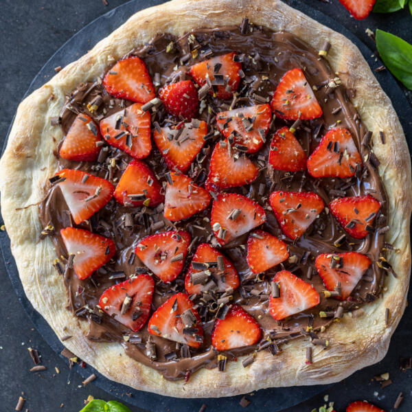 Nutella Pizza with berries and herbs next to it.