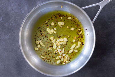 Oil with garlic and pepper in a pan.