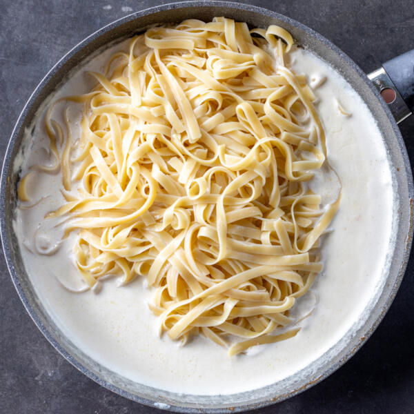 Sauce with pasta in a pan.