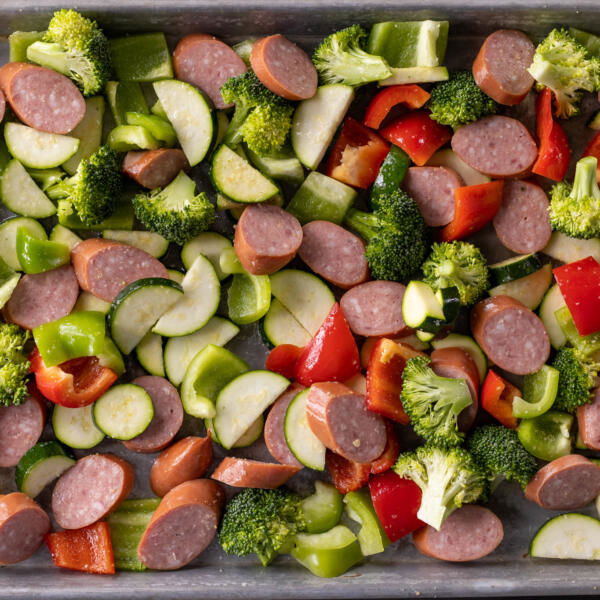 Sheetpan sausage and veggies before baking.