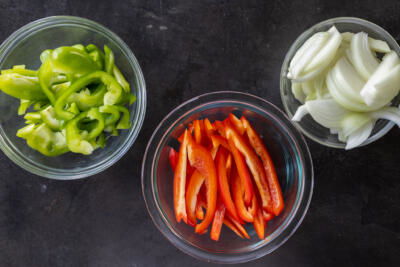 Sliced up veggies in bowls.