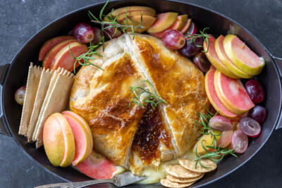 Baked Brie In Puff Pastry on a serving tray.