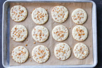 Butter Toffee Cookies baked on a baking sheet.