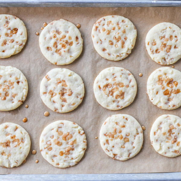 Butter Toffee Cookies baked on a baking sheet.