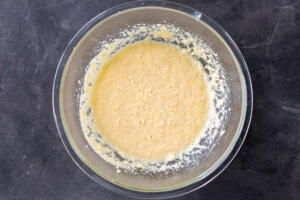 Egg butter and sugar in a bowl.