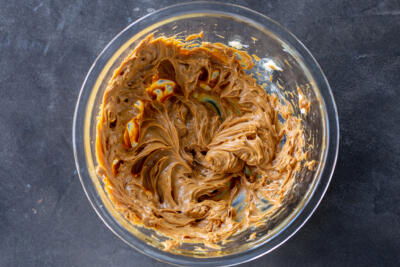 Dulce de leche and butter mixed in a bowl.