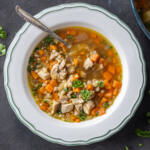 Chicken Barley Soup in a bowl with a spoon.