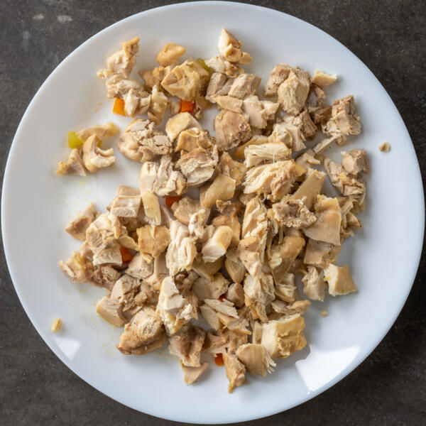 Cut up chicken in on a plate.